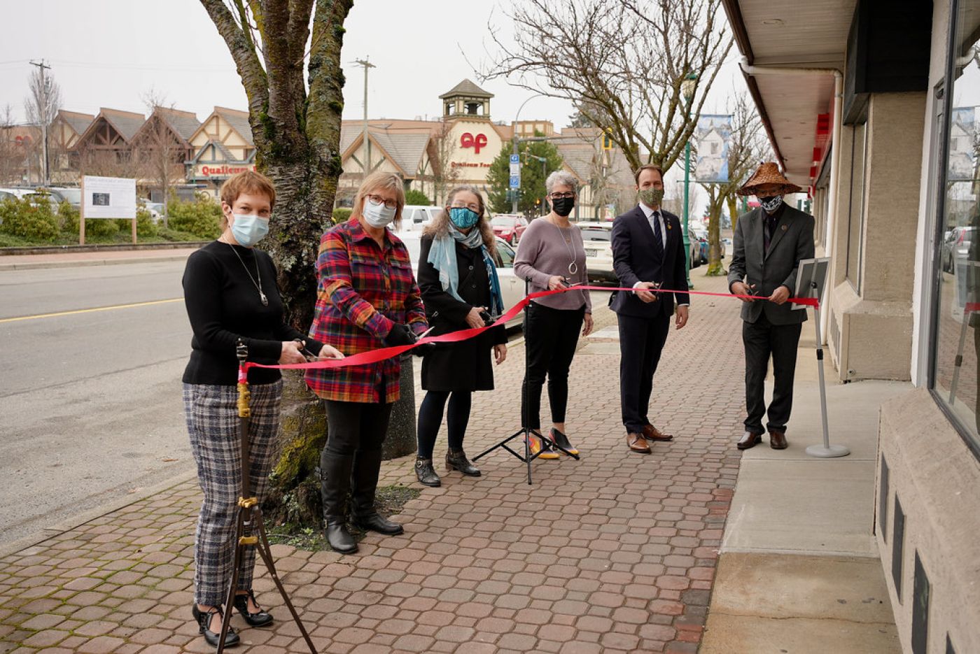 Local government officials cutting the ribbon at the Flowerstone Health Clinic in Qualicum Beach.