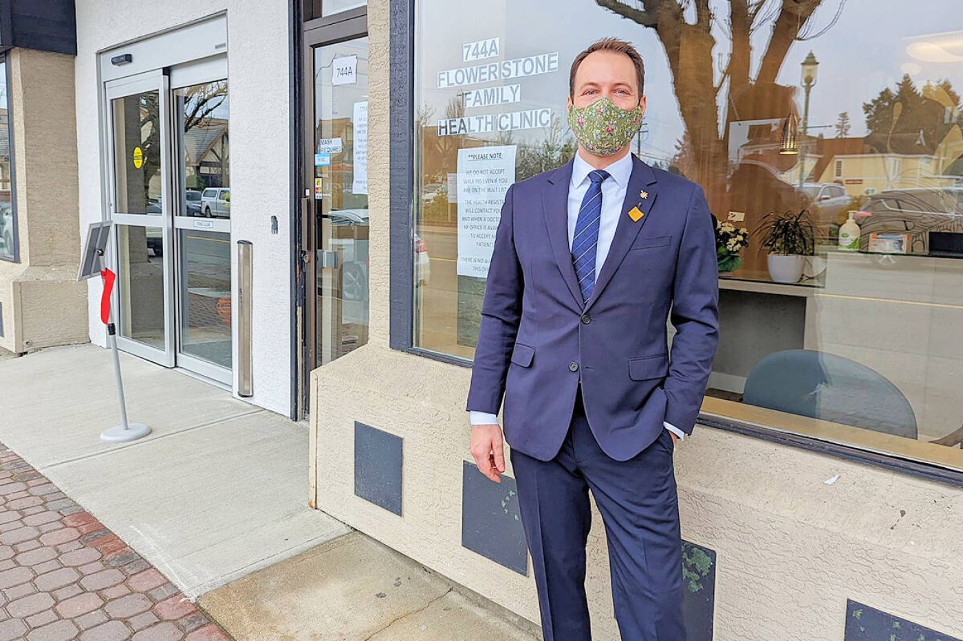 MLA Adam Walker standing in front of Flowerstone Health Clinic in QualicumBeach