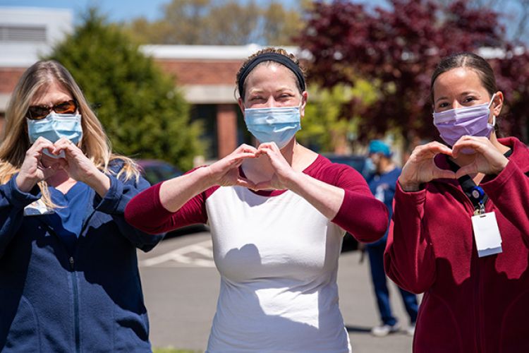 Nurses giving love hand signals