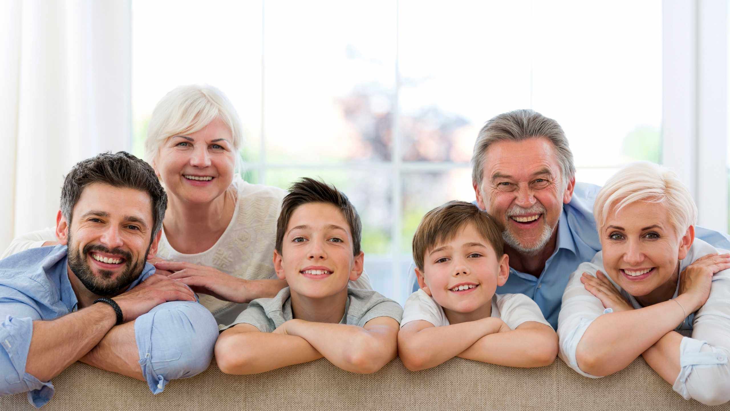 Happy family posing for camera on couch
